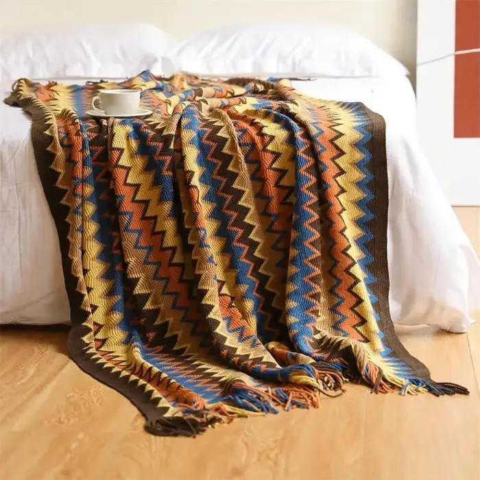 Couverture tricotée à la main avec pompons